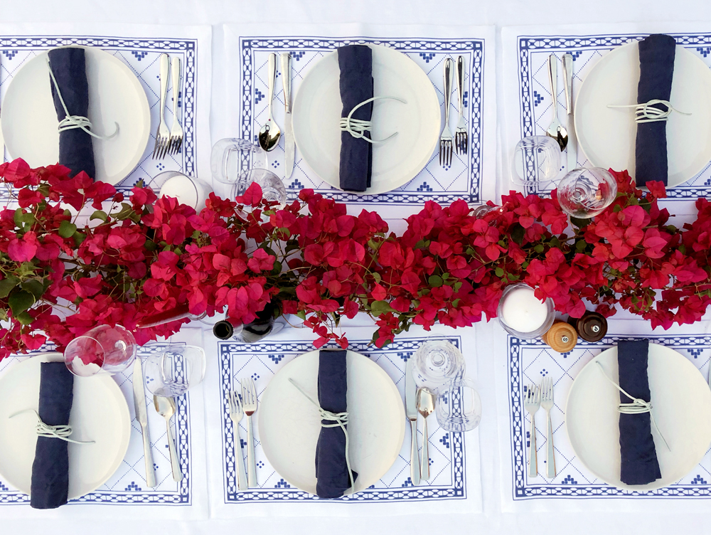Santorini theme Greek dinner party Blue and white placesetting bougainvillea