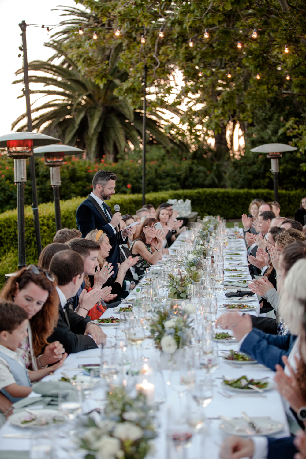 Long wedding table outdoor spring wedding California Malibu speeches low floral centerpieces