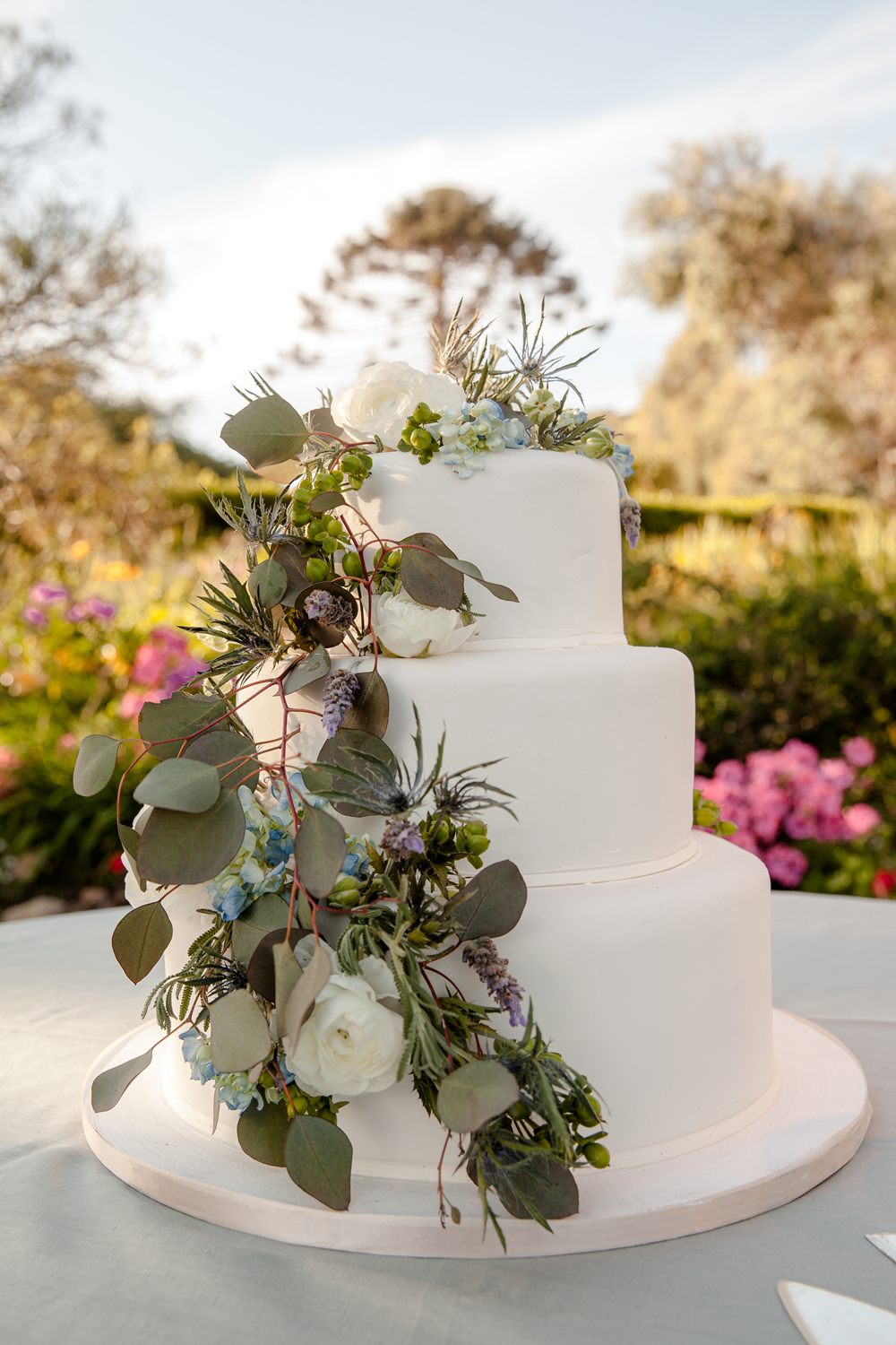 Traditional wedding fruit cake - fruit with white glazed marzipan decorated fresh flowers eucalyptus