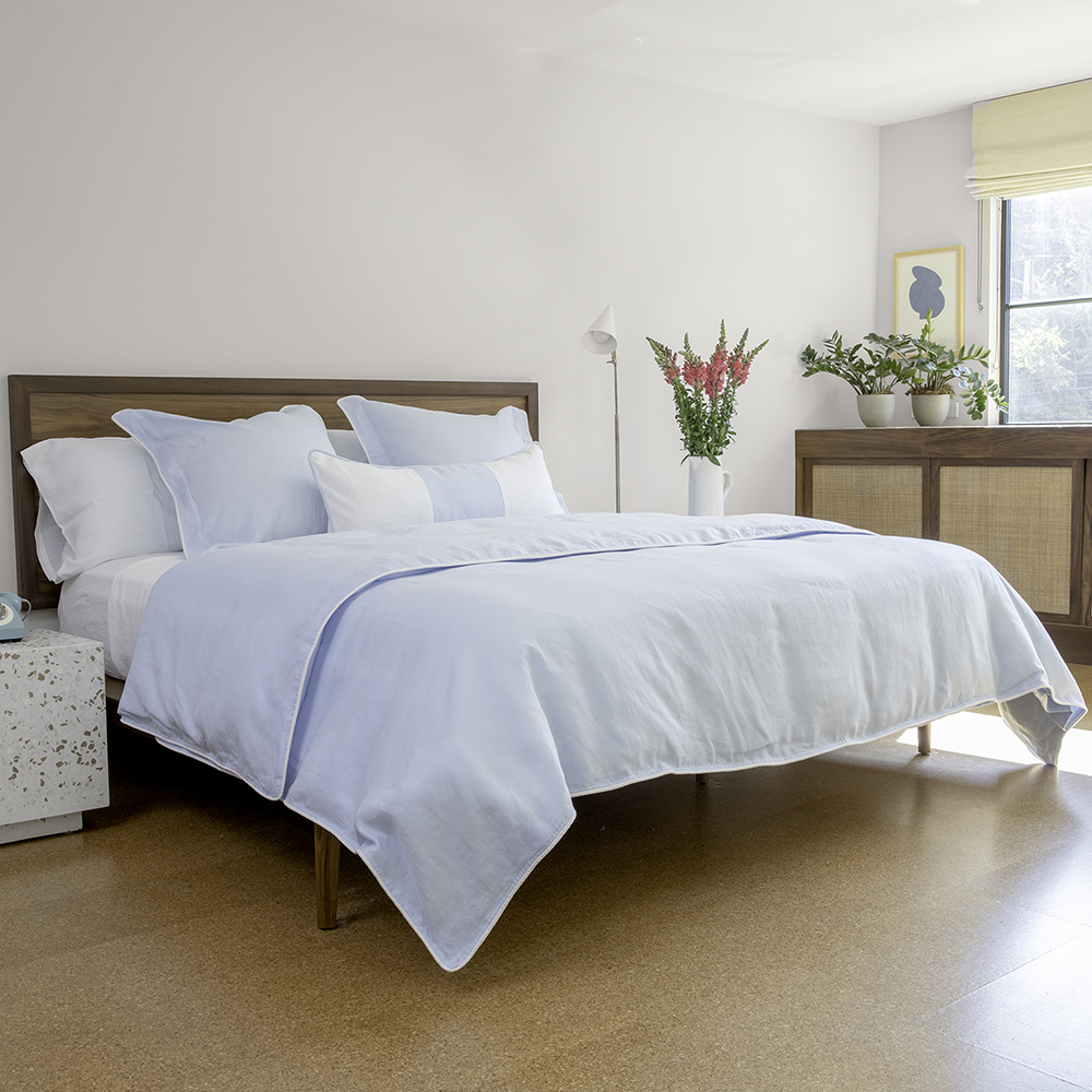 sky blue linen and white sheets duvet pillow guest room hotel bedding 