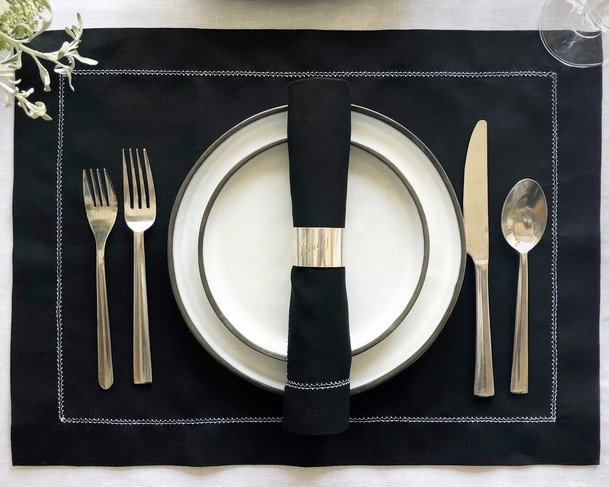black linen napkin with white hemstitch trim 